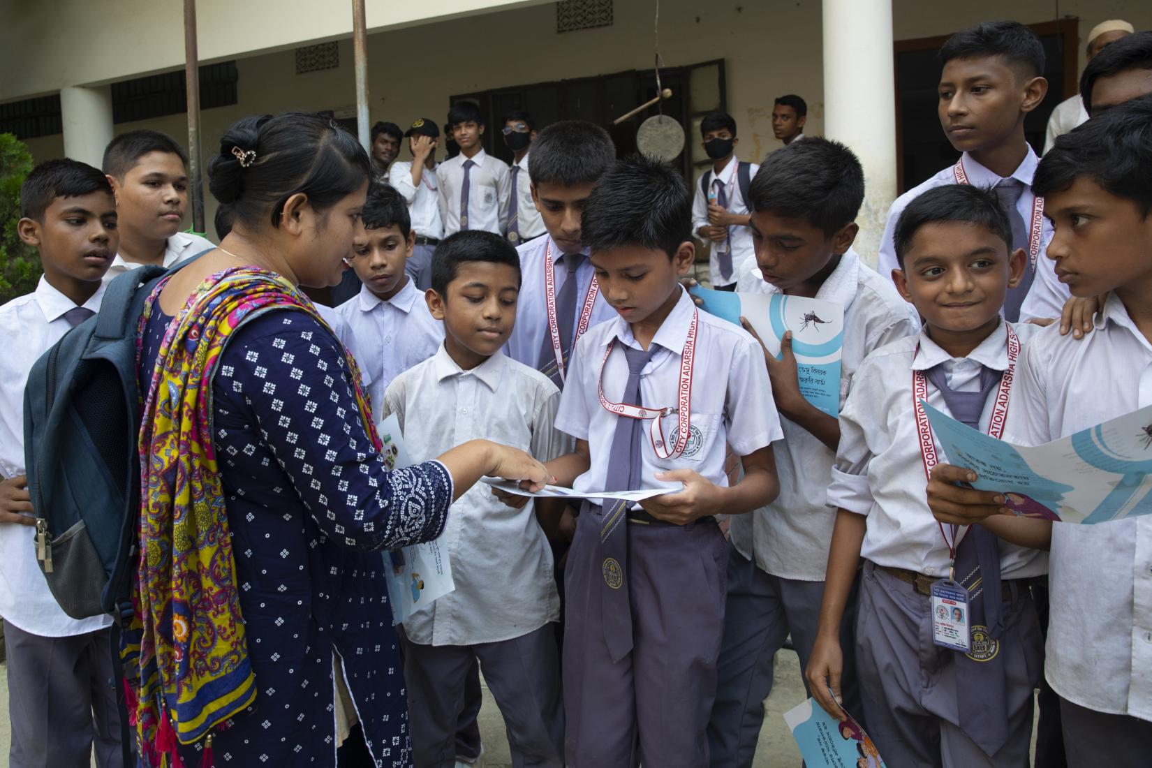 Sheuli Khatun speak to their students about dengue prevention in Dhalpur, Dhaka.
