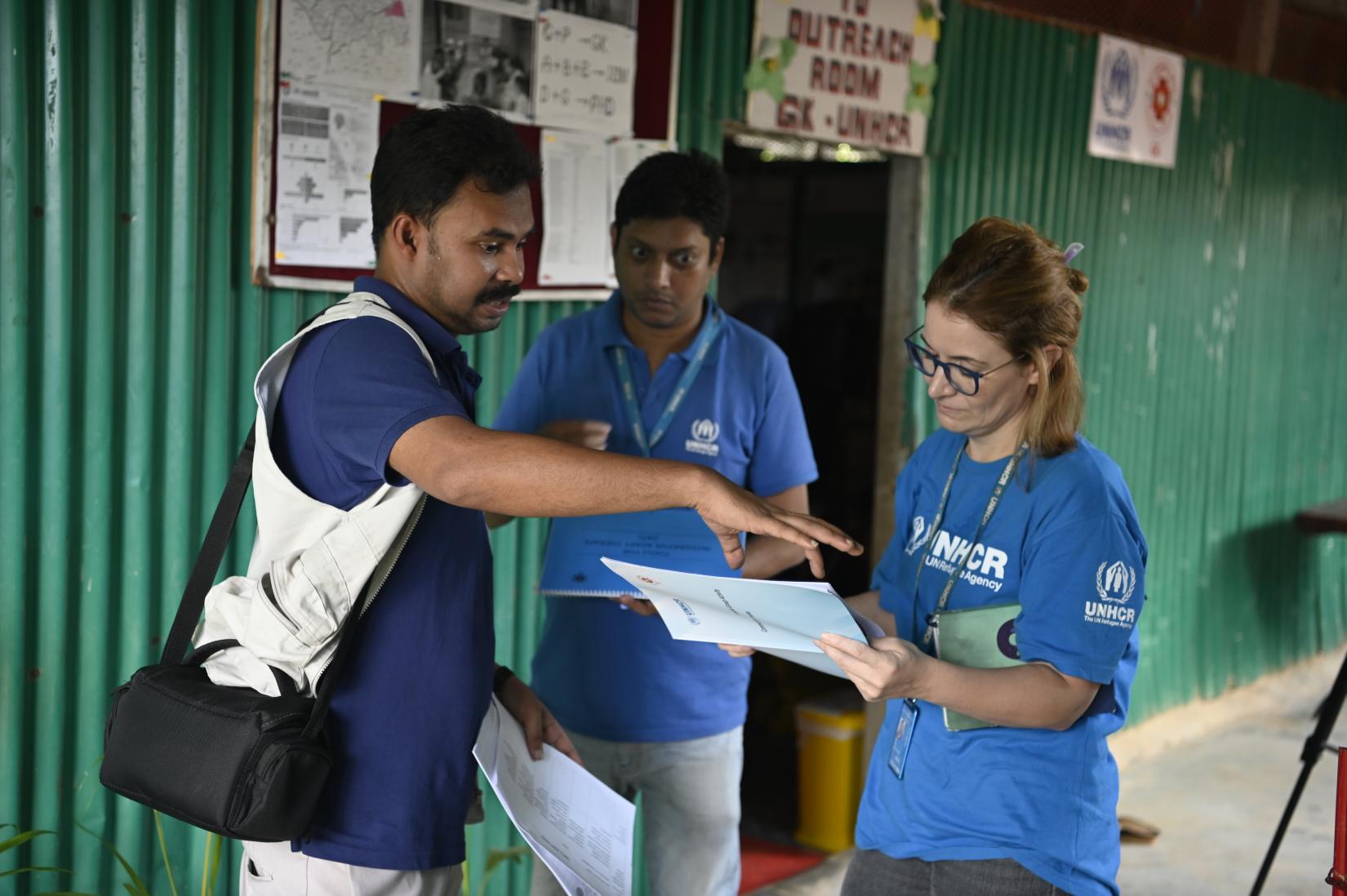 UNHCR mental health and psychosocial support officers Mahmudul Alam (middle) and Hivine Ali (right) with Md Asad Al Ahsan, an MHPSS officer from partner organization Gonoshasthaya Kendra (GK).